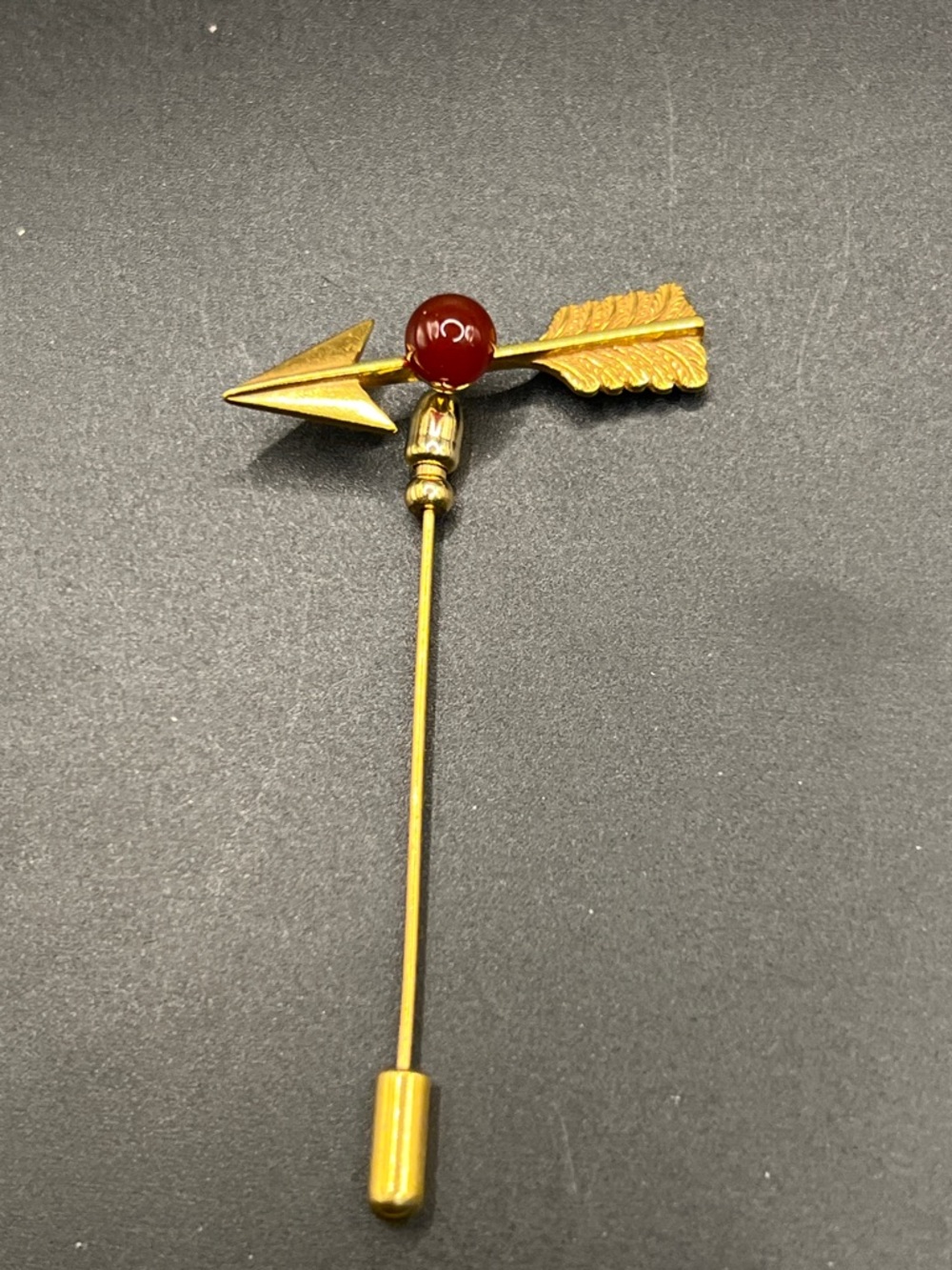 MMA Gold Arrow Stick Brooch with Red Bead